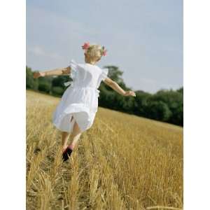  A Little Girl in a White Summer Dress, Running in a Field 