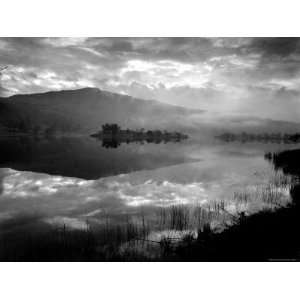 Atmospheric Landscape with Clouds and Hills Reflected in Water Premium 