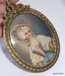 PAIR OF HANDPAINTED MINIATURE PORTRAITS. ORNATE BRONZE FRAME w/ BOW 