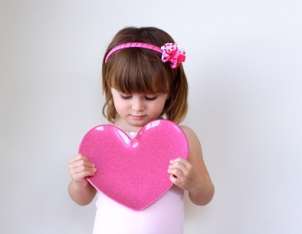 Cute little girl dressed in girls clothes for Valentines Day