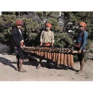 Three Boys Stand with the National Instrument of Guatemala, a Marimba 